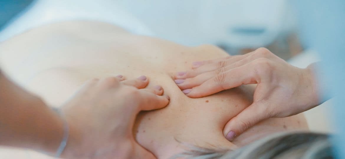 Person Massaging someone's upper back